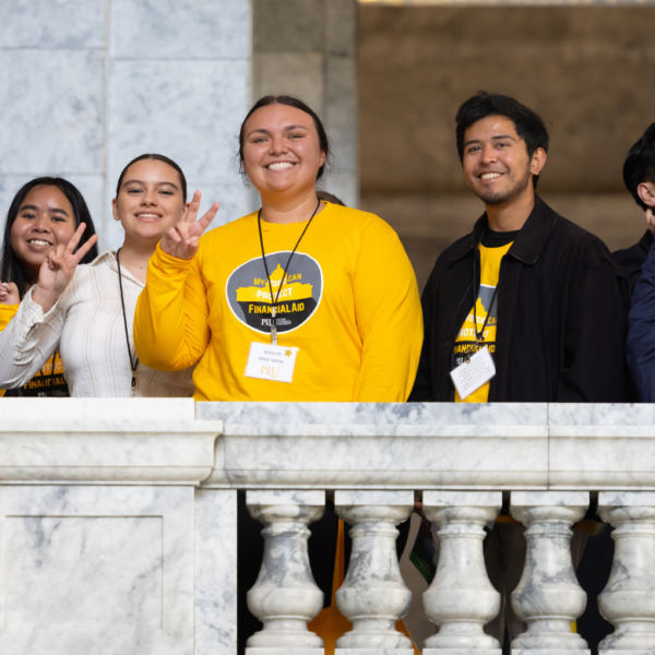 Students smile from the balcony