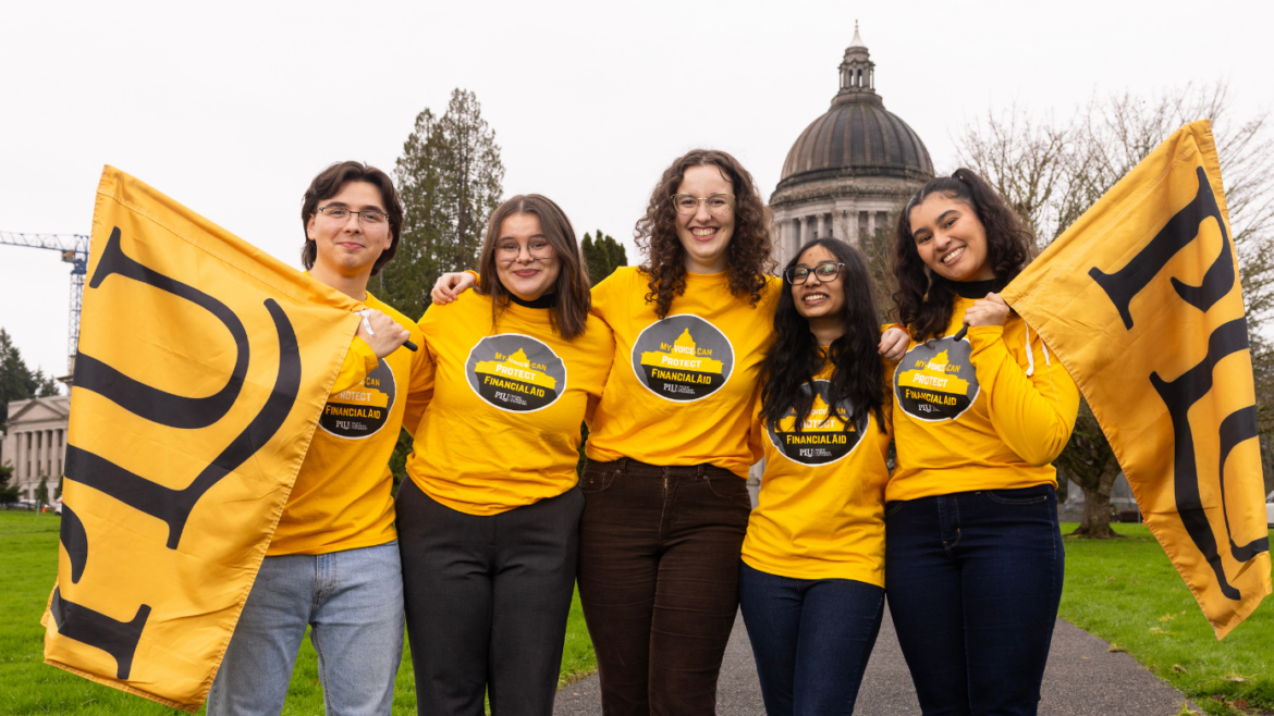 students in front of the capitol holding PLU banners