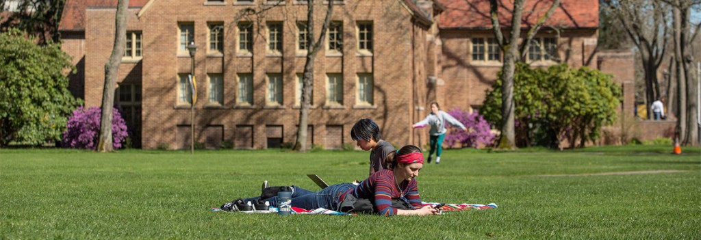 Students enjoying the outside by Xavier during the spring.