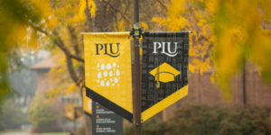 PLU black and gold banners surrounded by autumn trees