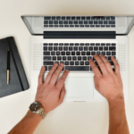 Job searching - laptop An image of an opened laptop with someone typing. Only their hands shown.