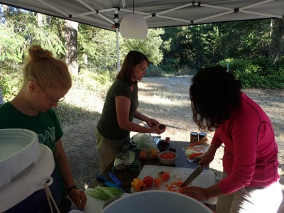 Paulina Przystupa (right), Georgia Abrams (center) and Emma Holm (left) preparing dinner at the field camp.