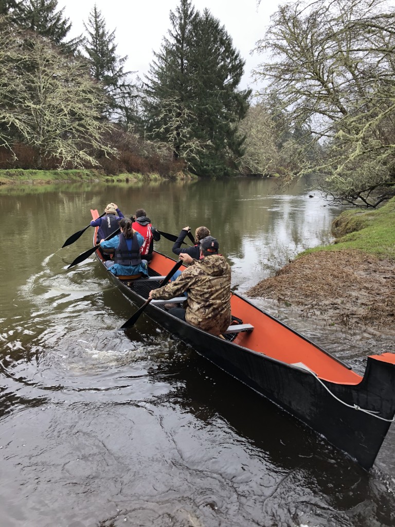 Students paddling canoe