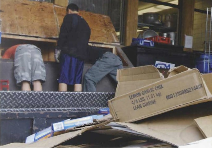 Students working with the cardboard compactor