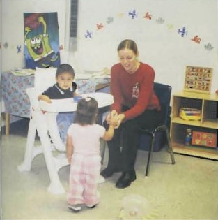 Pictured, Laura Fountain (’04) plays with children in the nursery at the women’s prison in Purdy.