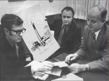 David Berntsen, Edgar Larson, and Clayton Peterson review drawings of the proposed 60-foot Anderson Clock Tower outside the University center that was erected later that year