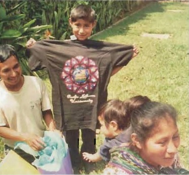 Young Guatemala boy holding a PLU tee shirt