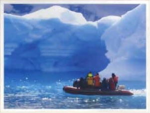 PLU students in a rubber boat floating by ice