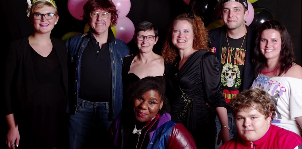 President Krise and Patty Krise join the Womens Center staff and students for a picture in 80's attire.