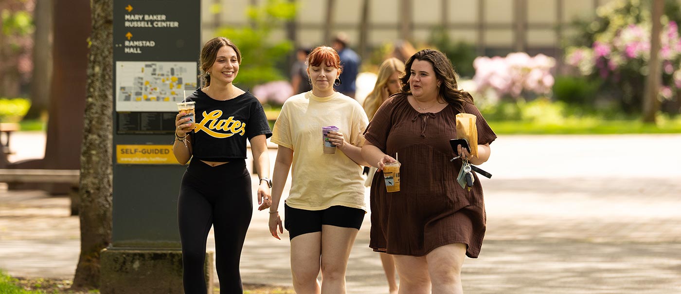 Students walk through a sunny spring campus, Tuesday, May 12, 2026, at PLU. (PLU Photo / Sy Bean)