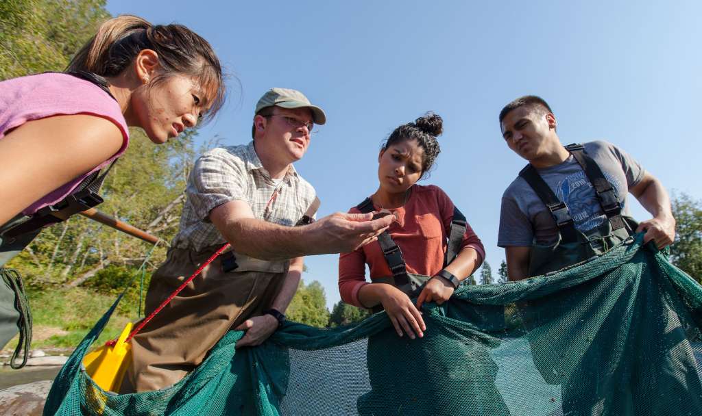 Professor Jacob Egge's collecting samples with students in the Nisqually River, 2017.