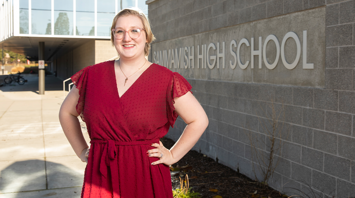 Biology alumna Becca Anderson stands in front of Sammamish high school sign