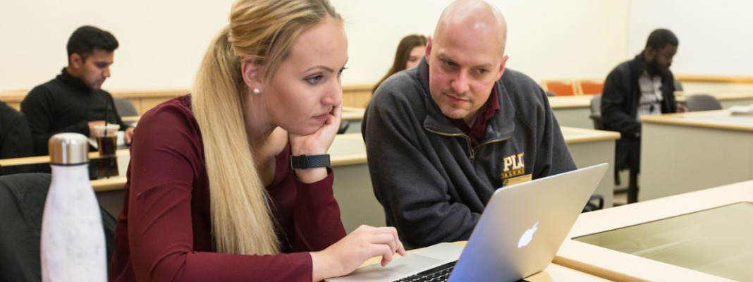 Two students viewing computer