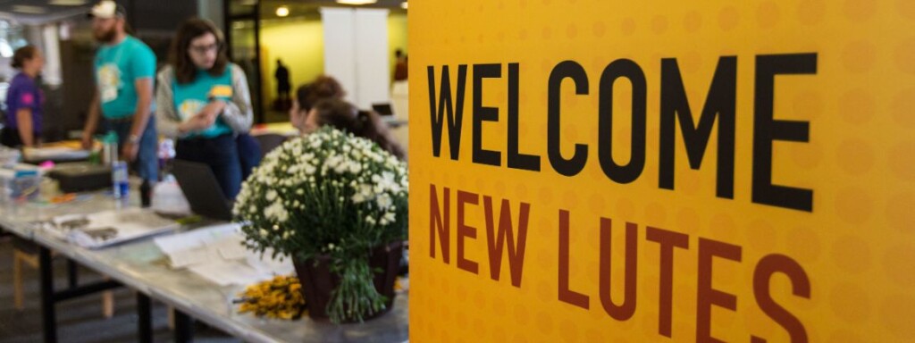 Students sitting at tables welcoming new students