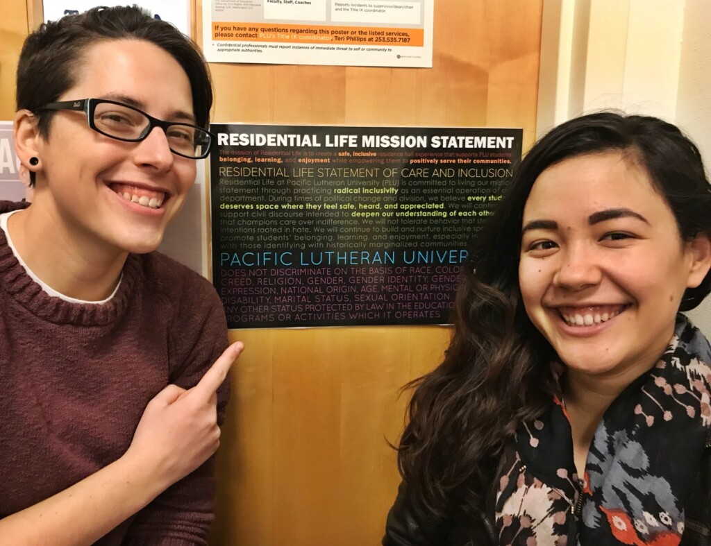 Former Community Directors, Maggie Hendrickson (Tingelstad Hall) and Tess Matsukawa (Harstad Hall/RHA Advisor) with the Residential Life Mission Statement posters (created Fall 2017).