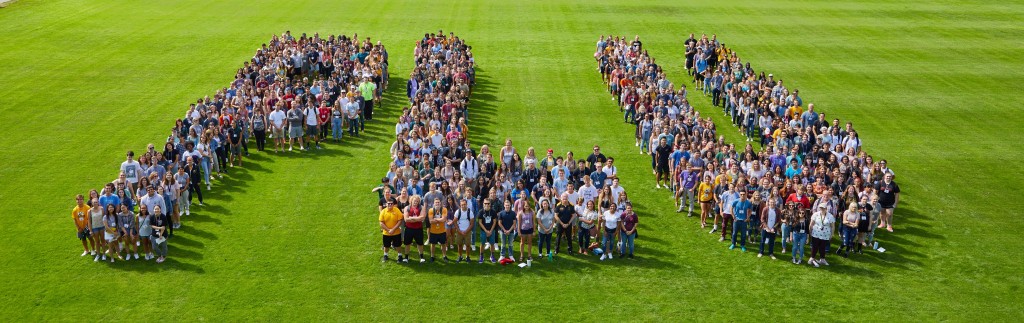 New students spelling out PLU on Foss field