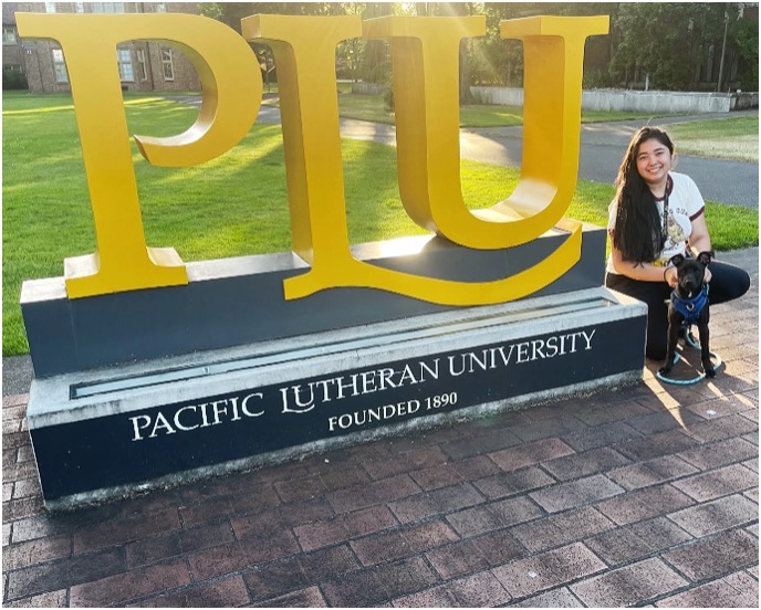 CD Dream Gonzales & her dog in front of PLU sign