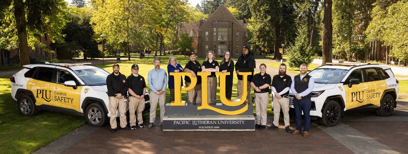PLU Safety team poses with vehicles on campus grounds