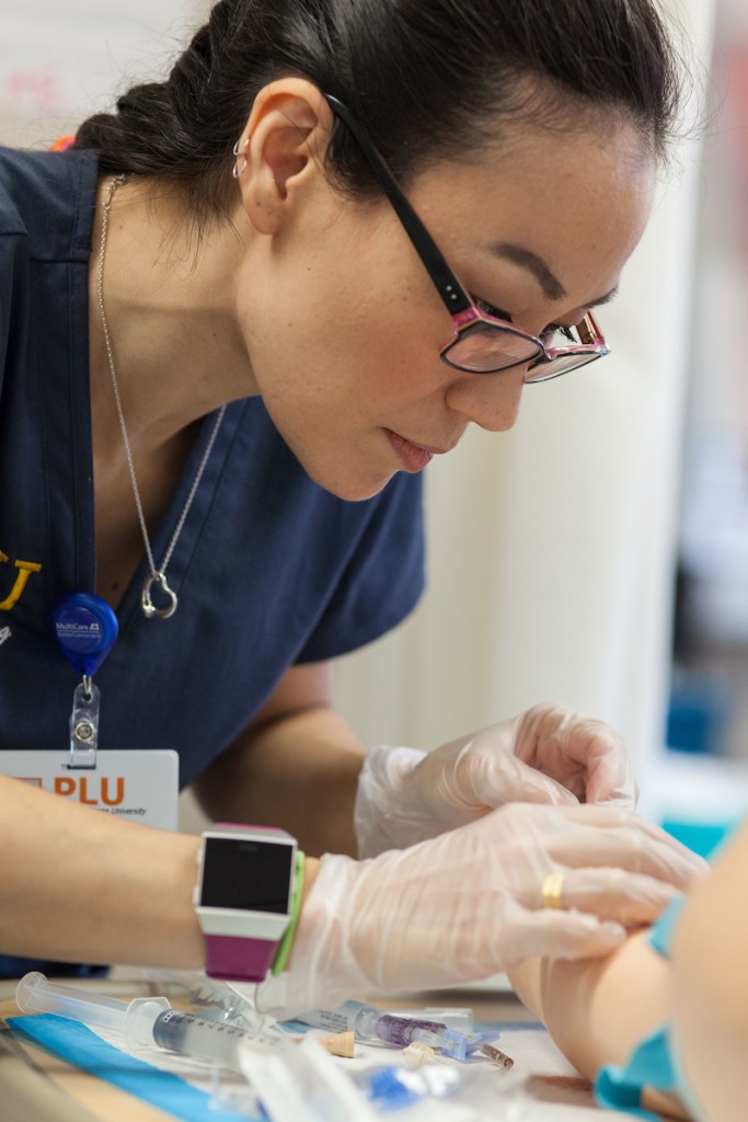 Nursing students in the Ramstad lab learning how to do blood transfusions and inserting intravenous lines at PLU, Tuesday, May 1, 2018. (Photo: John Froschauer/PLU)