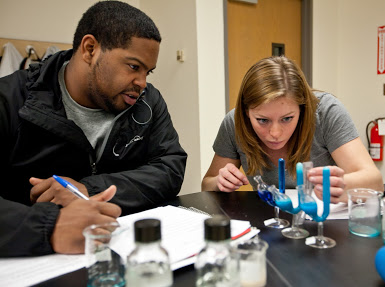 two students experimenting in biology class