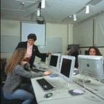 Professor Celine Dorner with students in a computer lab