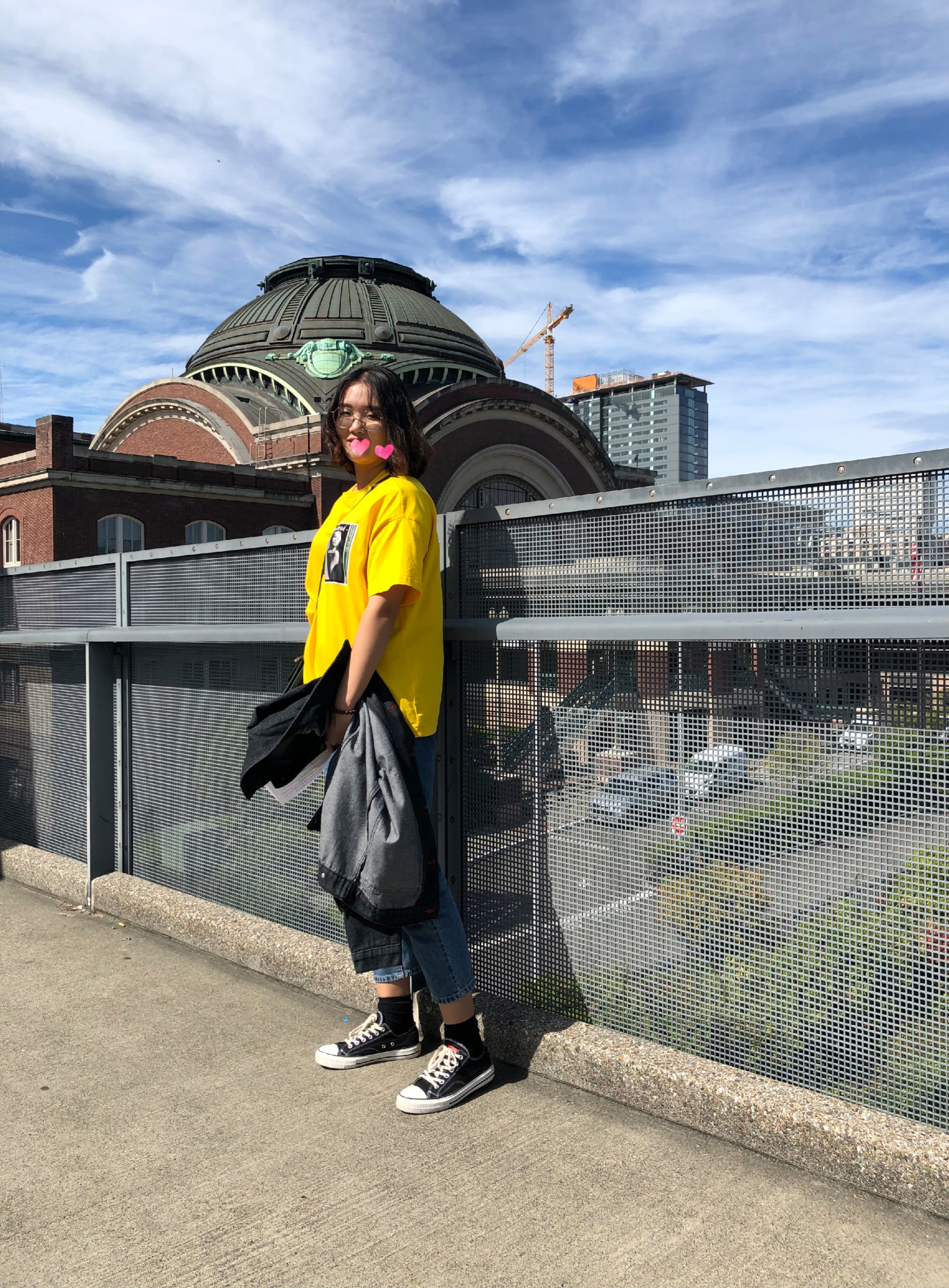 ABC Student stands on the Bridge of Glass with Union Station in the background