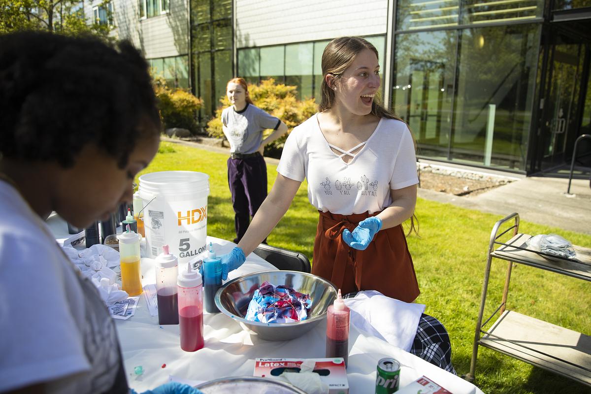 Young people having a picnic outdoors on a sunny day.
