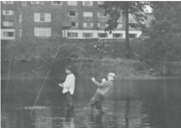 Two students pretending to fish in Clover Creek a long time ago