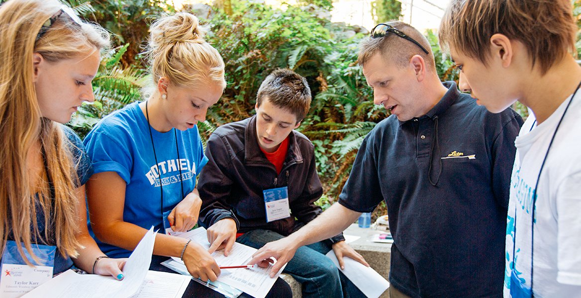 An advisor talking with a group of students
