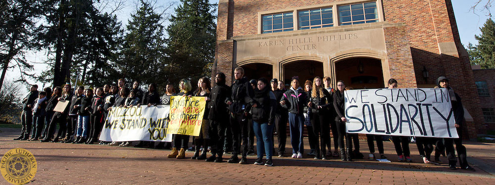 Students standing in Red Square holding signs of solidarity for Mizzoo