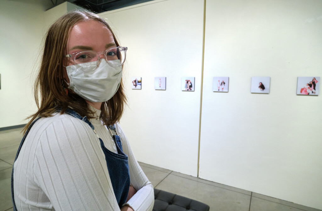 Jalyn Turner '22 stands in front of her collection of photographs (partial view)