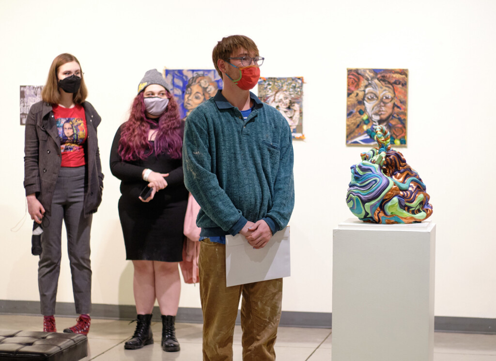 Jack Mahr '22 stands next to his sculpture "Glup" after his Honorable Mention is announced.