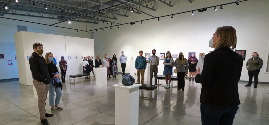 Students and guests assemble in the University Gallery for the opening of the 2021 Juried Student Art Exhibit