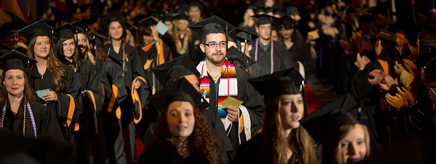 PLU students walking to their seats at commmencement