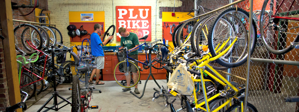 Isaac Moening-Swanson '15, front, and Riley Swanson '15, work on bicycles in the Bike Co-op