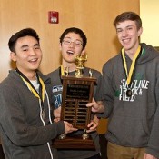 3 students holding trophy during High School programming contest at PLU on Saturday, Feb. 7, 2015. (Photo/John Froschauer/PLU)