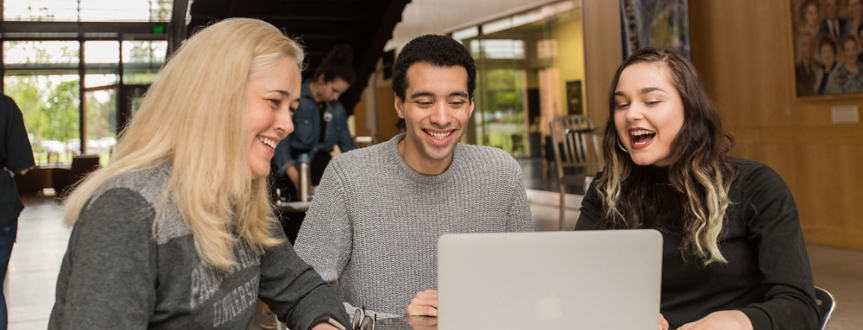 Professor and students looking at computer screen