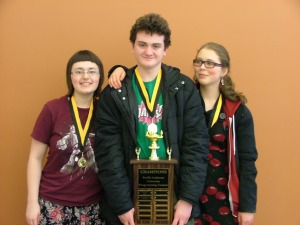 3 students holding trophy