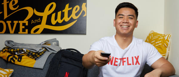 Adrian Ronquillo on couch with Netflix tshirt