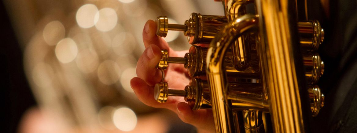 Closeup of fingers playing valves on an musical instrument