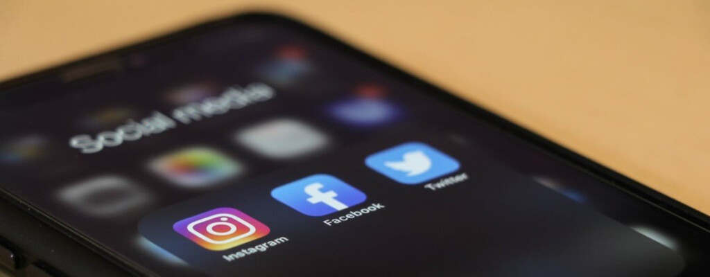 A smart phone with social media icons on the display screen.