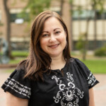 photo of a woman in an embroidered shirt standing in Red Square at PLU