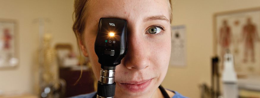 Student nurse looking through eyepiece