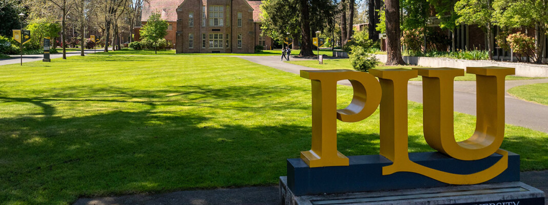PLU monument sign with Xavier in the background