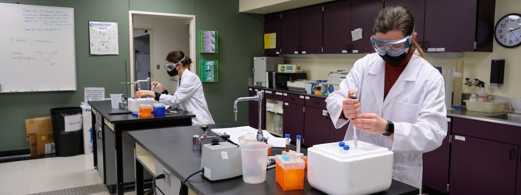 Two students in Chemistry lab wearing masks