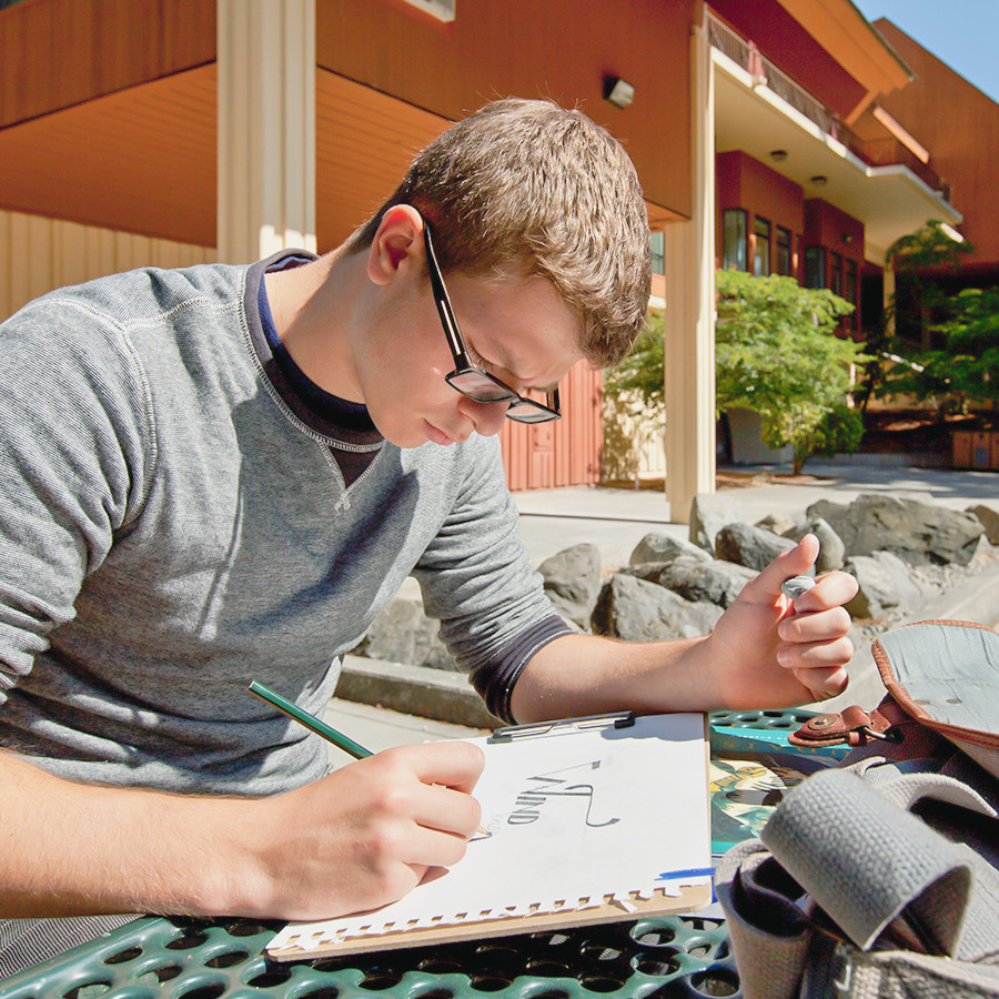 Student studying outside at a picnic table