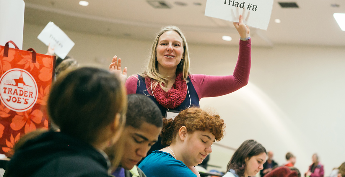 students talking in an auditorium