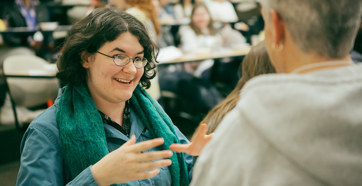 student talking to a staff member