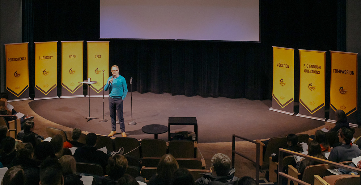 Daniel Lee on stage talking to students in the audience