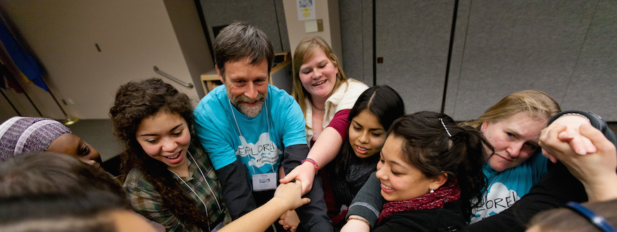 students and professor holding hands at explore retreat